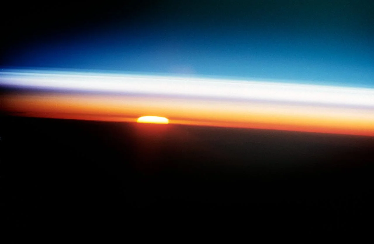 Layers of Earth’s atmosphere at sunset photographed from STS-52. NASA. Context photograph; not a refraction measurement.